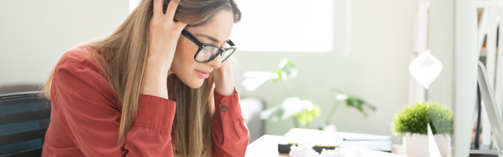 A business coach feeling frustrated with not being able to hit the 7-figure mark in her business because of undercharging