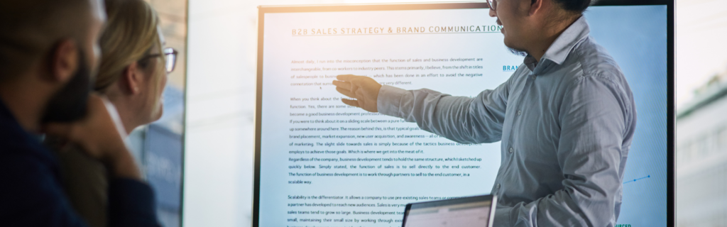 "A marketer standing in front of a computer, highlighting the importance of expert positioning and effective messaging in growing a 7-figure business."
