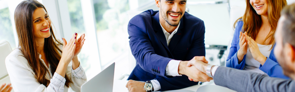 "A salesperson shaking hands with a client, representing the art of sales in driving consistent revenue for a 7-figure business."
