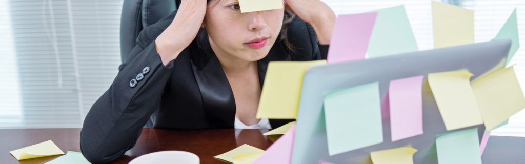Image of a tired and stressed coach or consultant sitting at their desk, surrounded by papers and staring at their computer screen. This image could depict the exhaustion and burnout that can occur when a coach or consultant is undercharging for their services and taking on too many clients. The image could convey the message that raising prices can help coaches and consultants manage their workload and prevent burnout, leading to better quality work and happier clients.