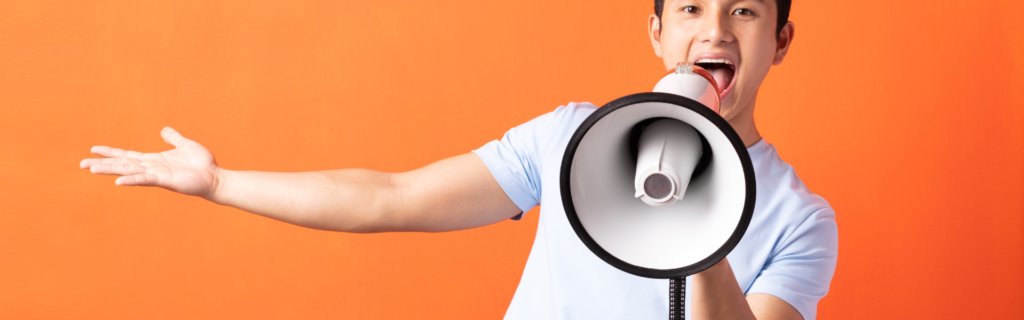 A person holding a megaphone, with words like "personalized messaging," "strong online presence," and "differentiation" written on it. This image represents the focus of coaches and consultants on effective marketing strategies to attract corporate clients. The megaphone symbolizes the need to communicate their expertise and unique value proposition.
