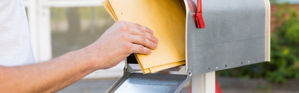 Show a person standing in front of an overflowing mailbox, looking overwhelmed. This can represent the negative impact of spamming.
